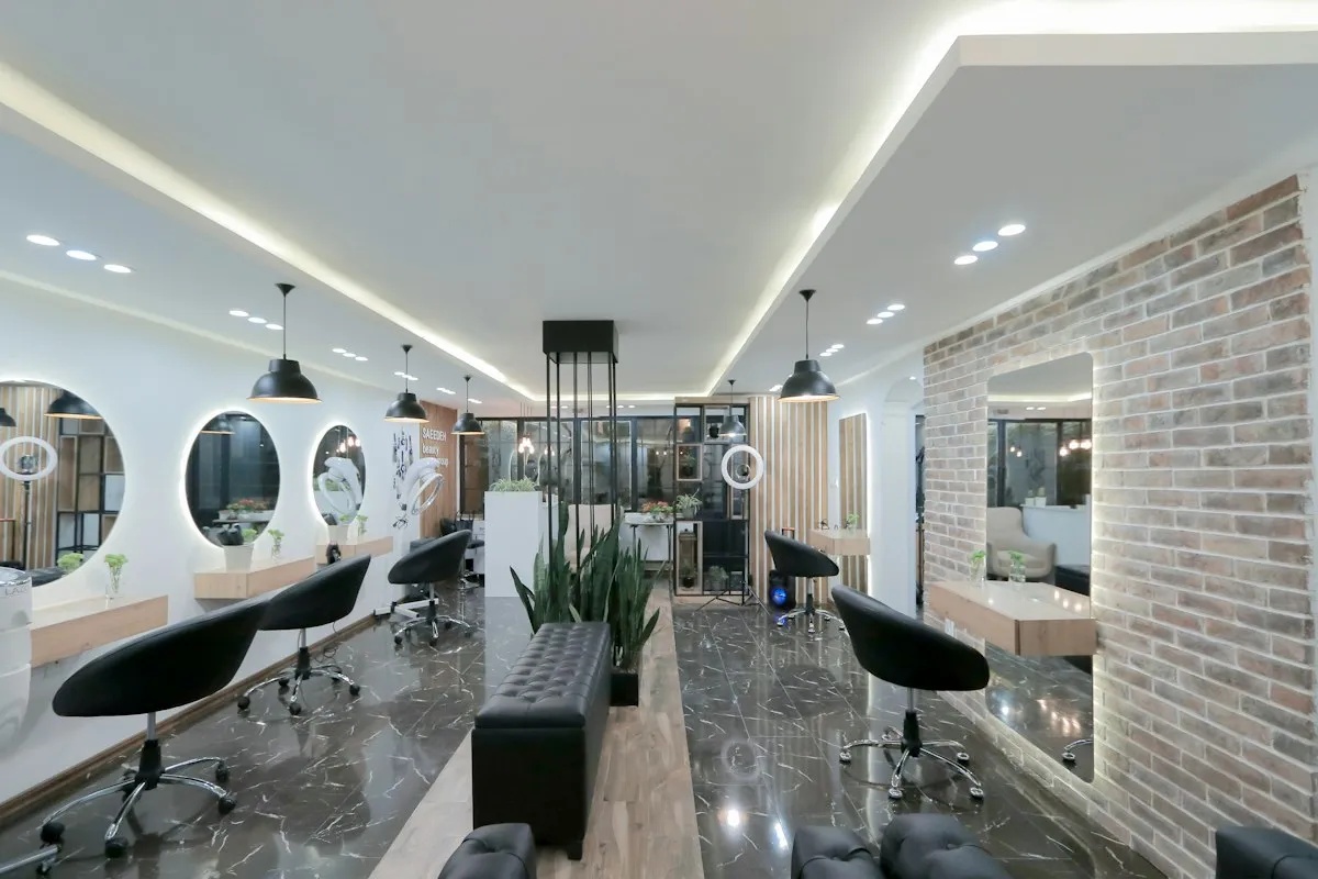 A modern salon with styling chairs and round mirrors